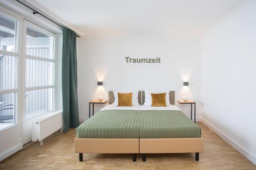 a bedroom with a bed and two lamps on two tables at UplandParcs W3 in Winterberg