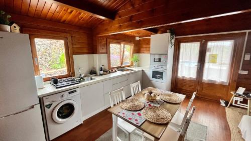 a kitchen with a table and a kitchen with a washer at Betenama - Rustic Hideaway with Pool & Garden in Tesbabo