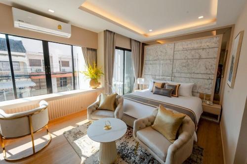 a hotel room with a bed and a large window at Bestier Hotel Hatyai in Hat Yai