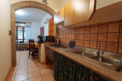 a kitchen with a sink and a counter top at Residenza Su Prelau in Gonnesa