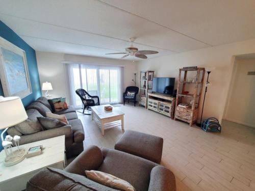 a living room with a couch and a table at Summerhouse 104- Direct Oceanfront condo in St. Augustine