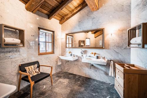 a bathroom with two sinks and a mirror at Chalets LA MOURRA in Val-d'Isère