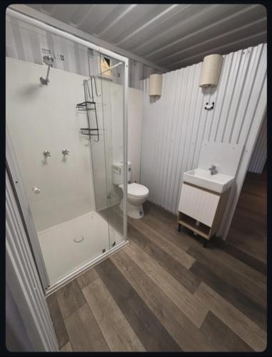 a bathroom with a shower and a toilet and a sink at Outback Getaway Home in Mount Isa
