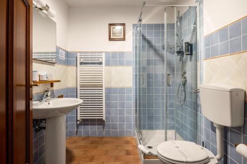 a bathroom with a shower and a toilet and a sink at Villa Trigona in Piazza Armerina