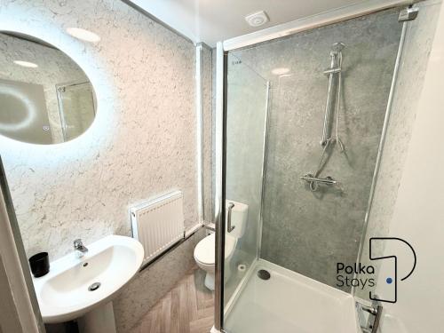a bathroom with a shower and a sink at Spacious Ormskirk Contractor Stay by PolkaStays in Ormskirk