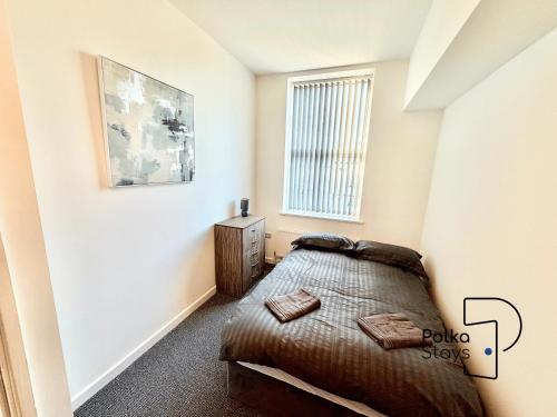 a bedroom with a bed and a window at Spacious Ormskirk Contractor Stay by PolkaStays in Ormskirk