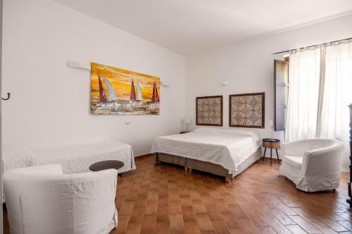 a bedroom with two beds and a painting on the wall at Villa Trigona in Piazza Armerina