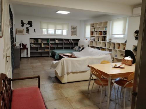 a living room with a bed and a table at Rodi House in Nafplio