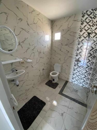 a bathroom with a sink and a toilet at Maison a midoun in Midoun