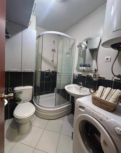 a bathroom with a shower and a toilet and a sink at Cozy City Studio in Podgorica, Blok 9 in Podgorica
