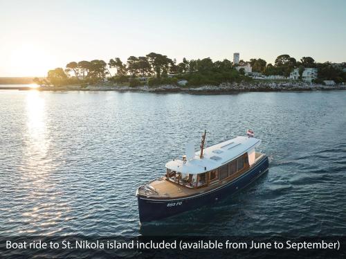 a boat floating on the water in a river at Valamar Riviera Hotel & Residence in Poreč