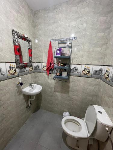 a bathroom with a toilet and a sink at Waves Surf House in Taghazout