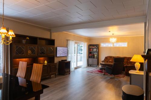 a living room with a couch and a table at Spacious Apartment - City Center in Stryn