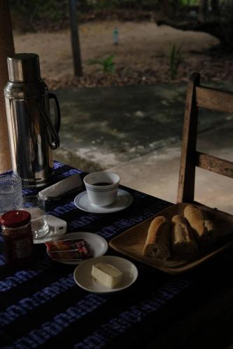 a table with a plate of bread on a table at Campement Outouka in Kafountine
