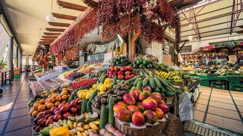 a market with many different types of fruits and vegetables at In City - Funchal Heart with Rooftop in Funchal