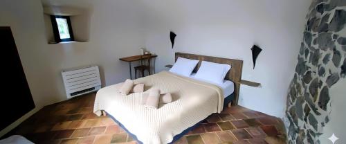 a bedroom with a bed with two pillows at MAS Estrela Chambre Lo Nis in Bessèges