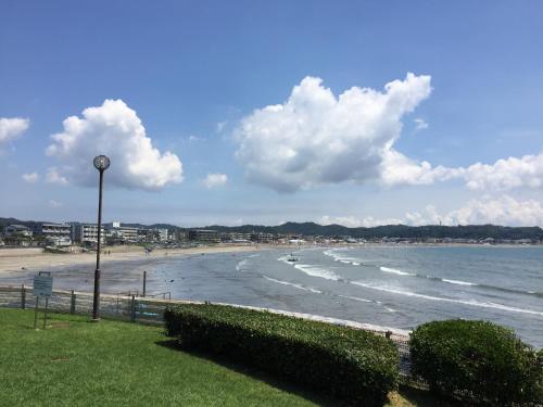 a beach with a street light and the ocean at IZA Kamakura Guest House and Bar in Kamakura