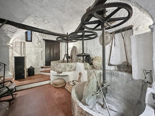 a bathroom with a bath tub in a stone room at Old Mill in Pigna