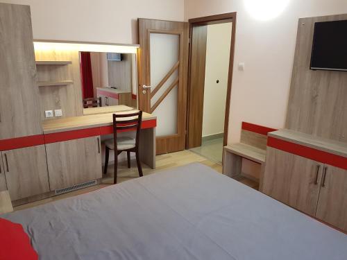 a room with a bed and a desk and a mirror at Ego 2 Guesthouse in Belogradchik