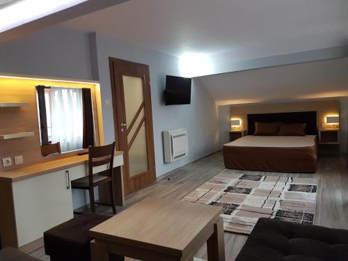 a bedroom with a bed and a desk and a table at Ego 2 Guesthouse in Belogradchik