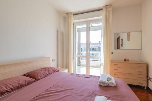 a bedroom with a bed with two towels on it at Angelic Darsena Apartment in Ravenna
