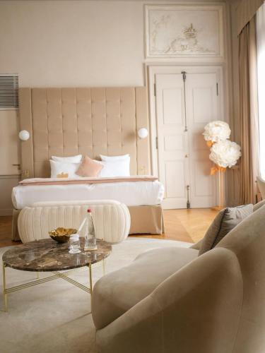 a living room with a bed and a coffee table at Hôtel Richer De Belleval - Relais & Châteaux in Montpellier