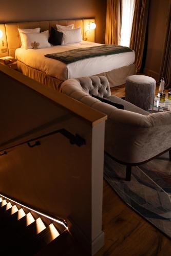 a hotel room with a bed with avisor at Hôtel Richer De Belleval - Relais & Châteaux in Montpellier