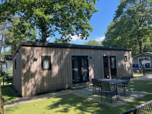 a small shed with a table and chairs at Bospark Wolfsven - 1511 in Mierlo