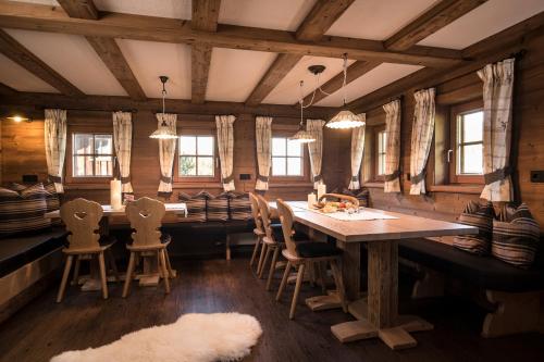 a dining room with a wooden table and chairs at Bergchalet Rauchenhof in Reith im Alpbachtal