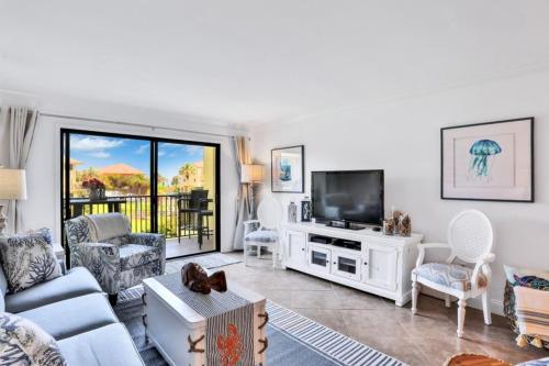 a living room with a couch and a tv at Summerhouse 147 condo in St. Augustine