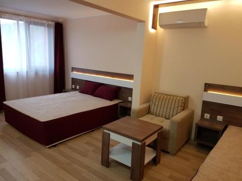 a small bedroom with a bed and a chair at Ego 2 Guesthouse in Belogradchik