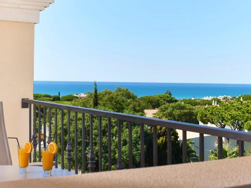 a balcony with a view of the ocean at Ria Park Hotel & Spa in Vale do Lobo