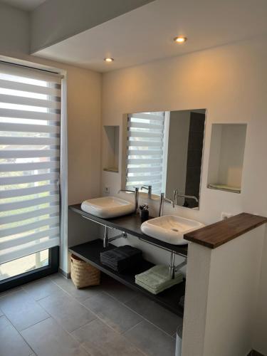 a bathroom with two sinks and a mirror at Guesthouse in Neuhäusel