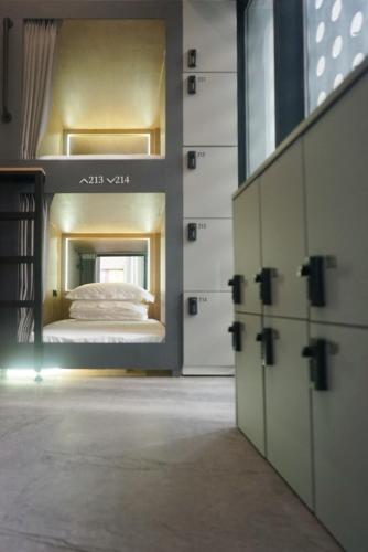 a bedroom with a bunk bed in a room at L YOUNG Inn Capsule Hotel Myeongdong in Seoul