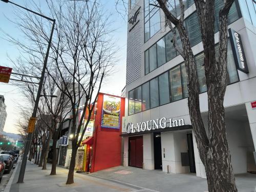 a building with a growing firm sign on a street at L YOUNG Inn Capsule Hotel Myeongdong in Seoul