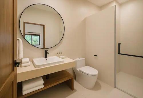 a bathroom with a sink and a mirror and a toilet at Exclusive Boho-Style 4-Bedroom Villa with Beautiful Private Tropical Pool, Spacious Outdoor BBQ & Chill-Out Terrace, Walking Distance to the Beach in Nathon Bay
