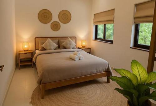 a bedroom with a bed with two teddy bears on it at Exclusive Boho-Style 4-Bedroom Villa with Beautiful Private Tropical Pool, Spacious Outdoor BBQ & Chill-Out Terrace, Walking Distance to the Beach in Nathon Bay