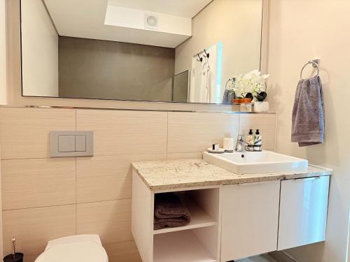 a bathroom with a sink and a mirror at Instellies Andringa Walk Apartment in Stellenbosch