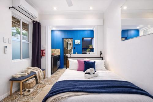 a bedroom with a large bed with blue walls at Balmain Village Retreat AC Free Street Parking City 3km in Sydney