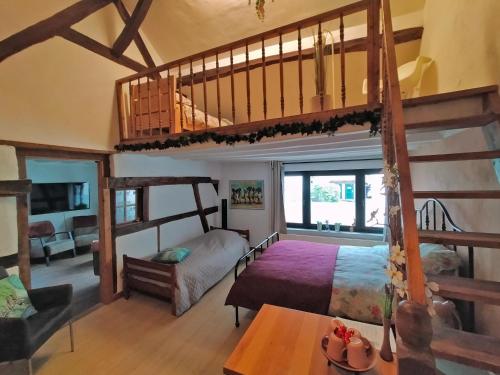 a bedroom with two bunk beds and a staircase at BnB Het Geluk van Limburg in Mechelen