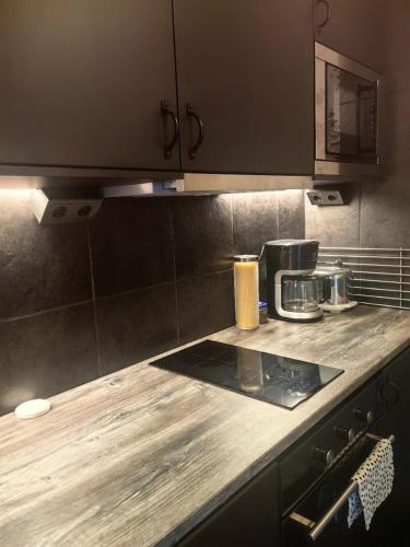 a kitchen with a wooden counter top with a coffee maker at Farm under the stars in Vallentuna