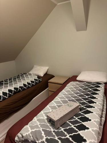 a bedroom with two beds with a suitcase on the bed at Farm under the stars in Vallentuna