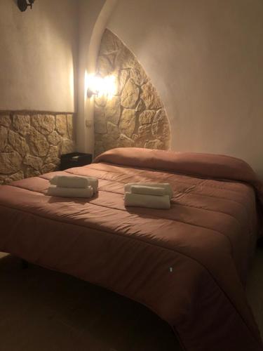 a bedroom with a bed with two towels on it at B&B Santa Chiara Home in Caserta