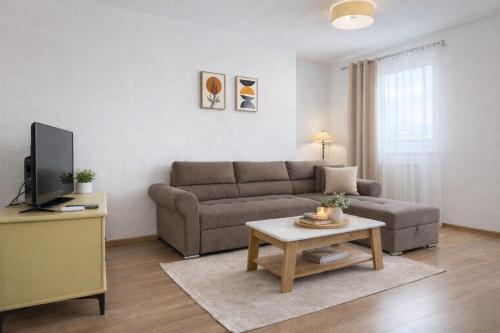 a living room with a couch and a table at Apartmani Sun & Moon in Žepče