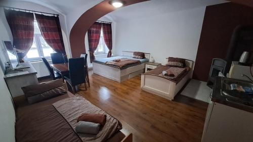 a living room with two beds and a couch at Tichý mlýn in Pelhřimov