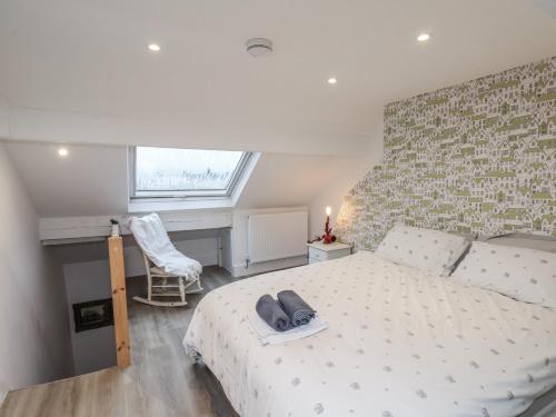 a bedroom with a large white bed and a window at 1 Castle Terrace in Thirsk
