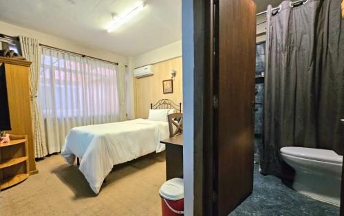a hotel room with a bed and a bathroom at Sagarmatha Apartment Hotel in Pātan