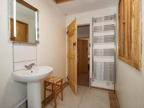 a bathroom with a sink and a mirror at 1 Dingle Cottage in Worcester