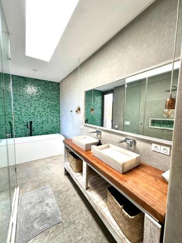 a bathroom with two sinks and a large mirror at Villa Terra Akal in Essaouira