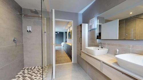 a bathroom with a sink and a shower at Portview and Brenwin Guesthouse in Cape Town